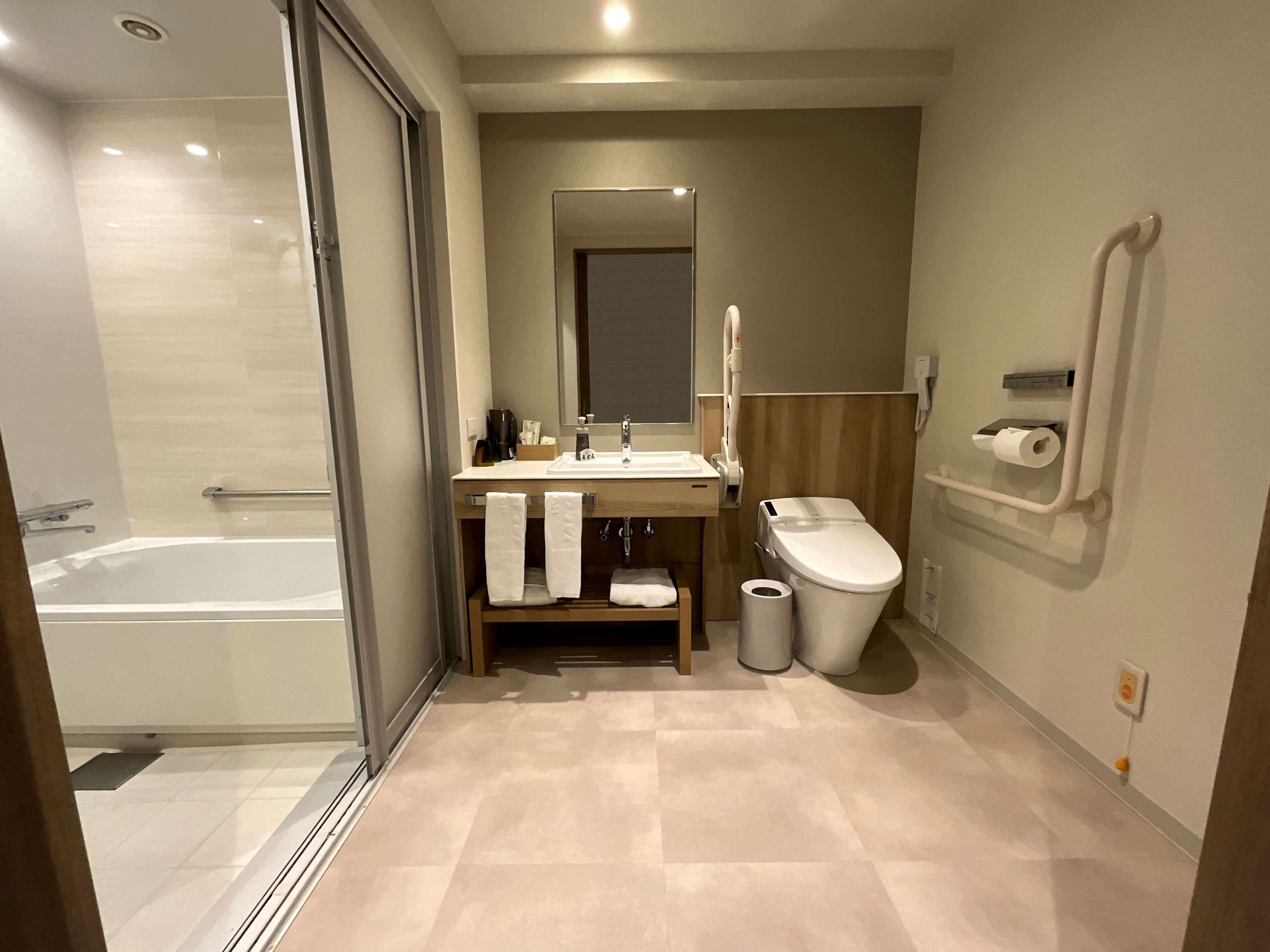 Photo of the handicap accessible bathroom, washbasin, and toilet